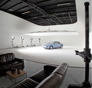 a car is parked in an empty room