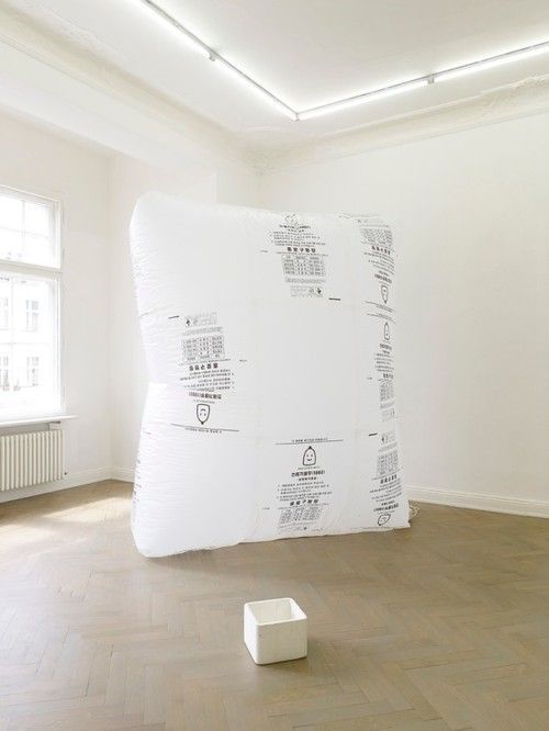 a room with a large white piece of paper on the floor