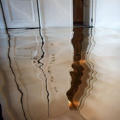 a reflection of a door in a puddle of water