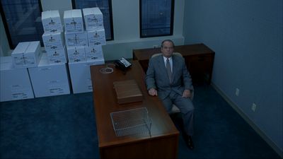 a man sitting at a desk in an office