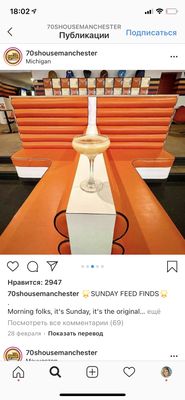 an orange table with a wine glass on top of it