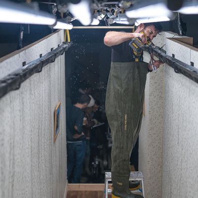 a man standing in a room holding a gun