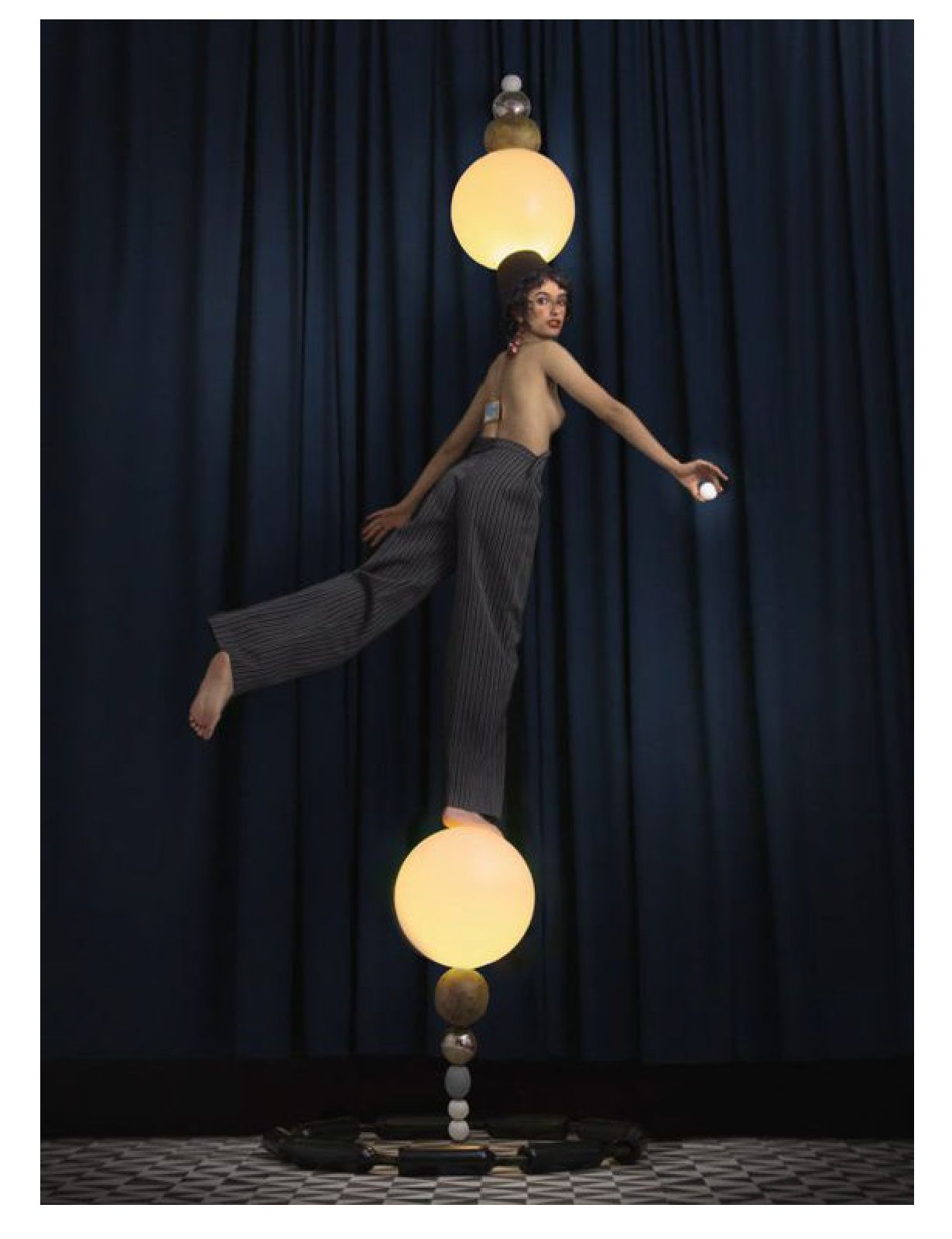 a woman standing on top of a table next to a lamp