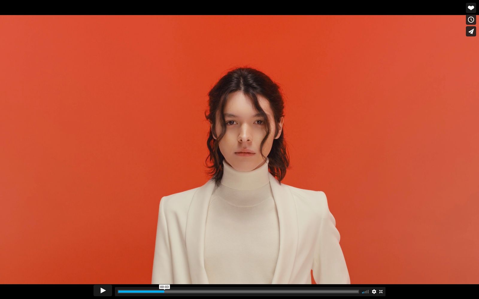 a woman in a white shirt and a red background