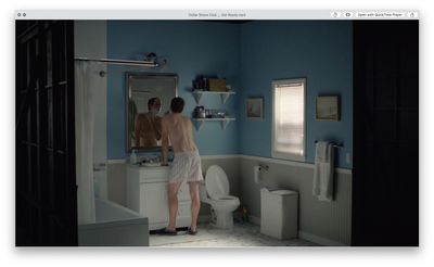 a man standing in front of a mirror in a bathroom