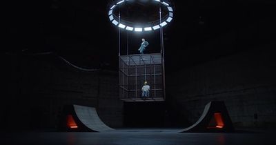 a man standing on top of a ramp in the dark