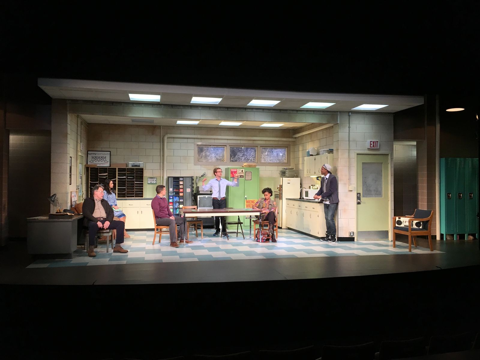 a group of people sitting around a table on a stage