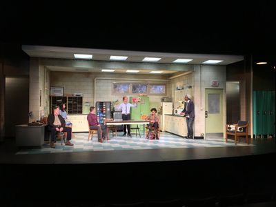 a group of people sitting around a table on a stage