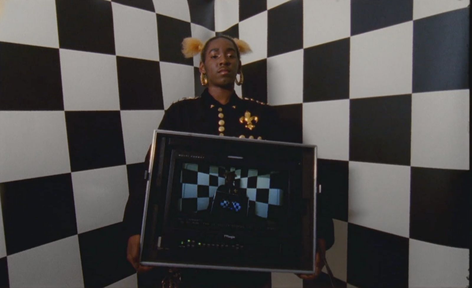 a woman in a black and white checkered room holding a black and white framed