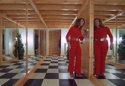 two women in red outfits standing in a room