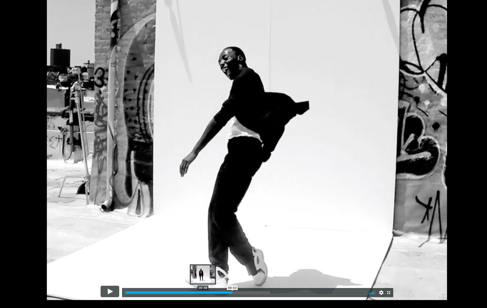 a black and white photo of a man on a skateboard