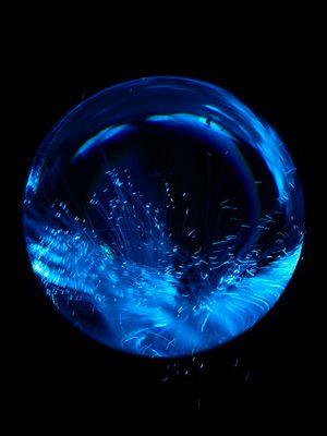 a close up of a blue object in the dark