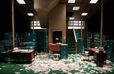 a room filled with lots of desks and filing cabinets