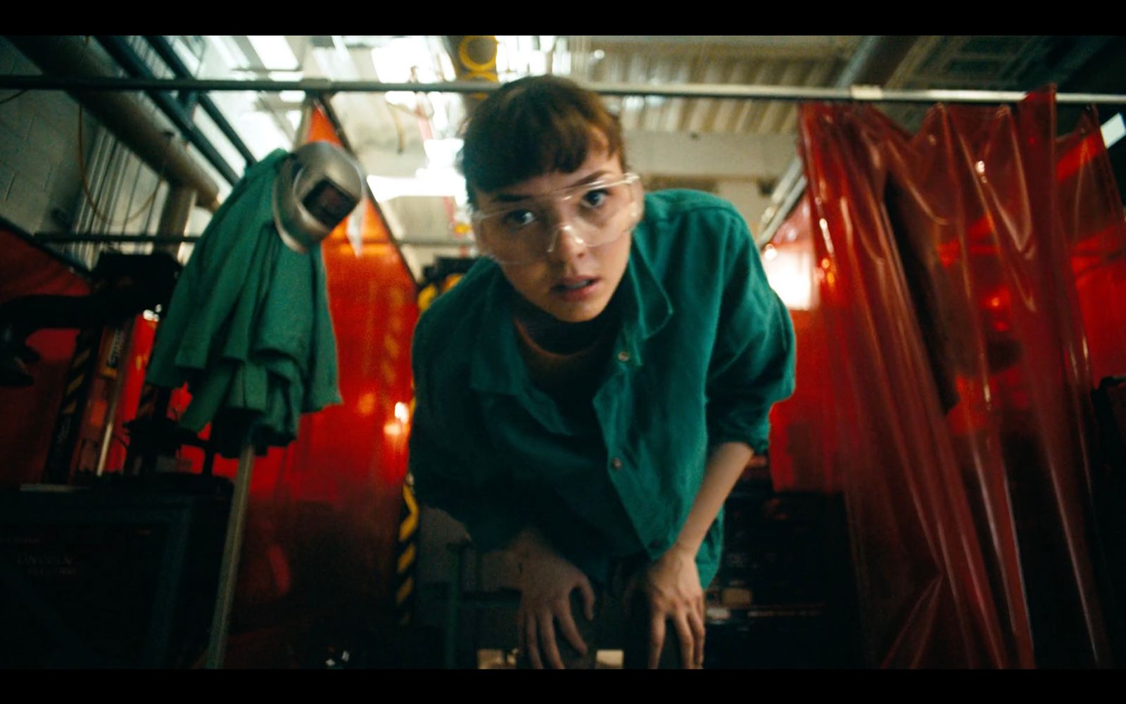 a woman in a green shirt is looking at something