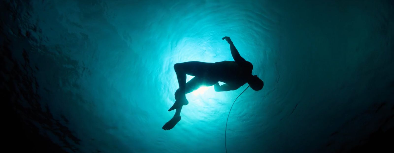 a silhouette of a person in a body of water