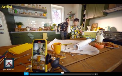 a couple of people standing in a kitchen