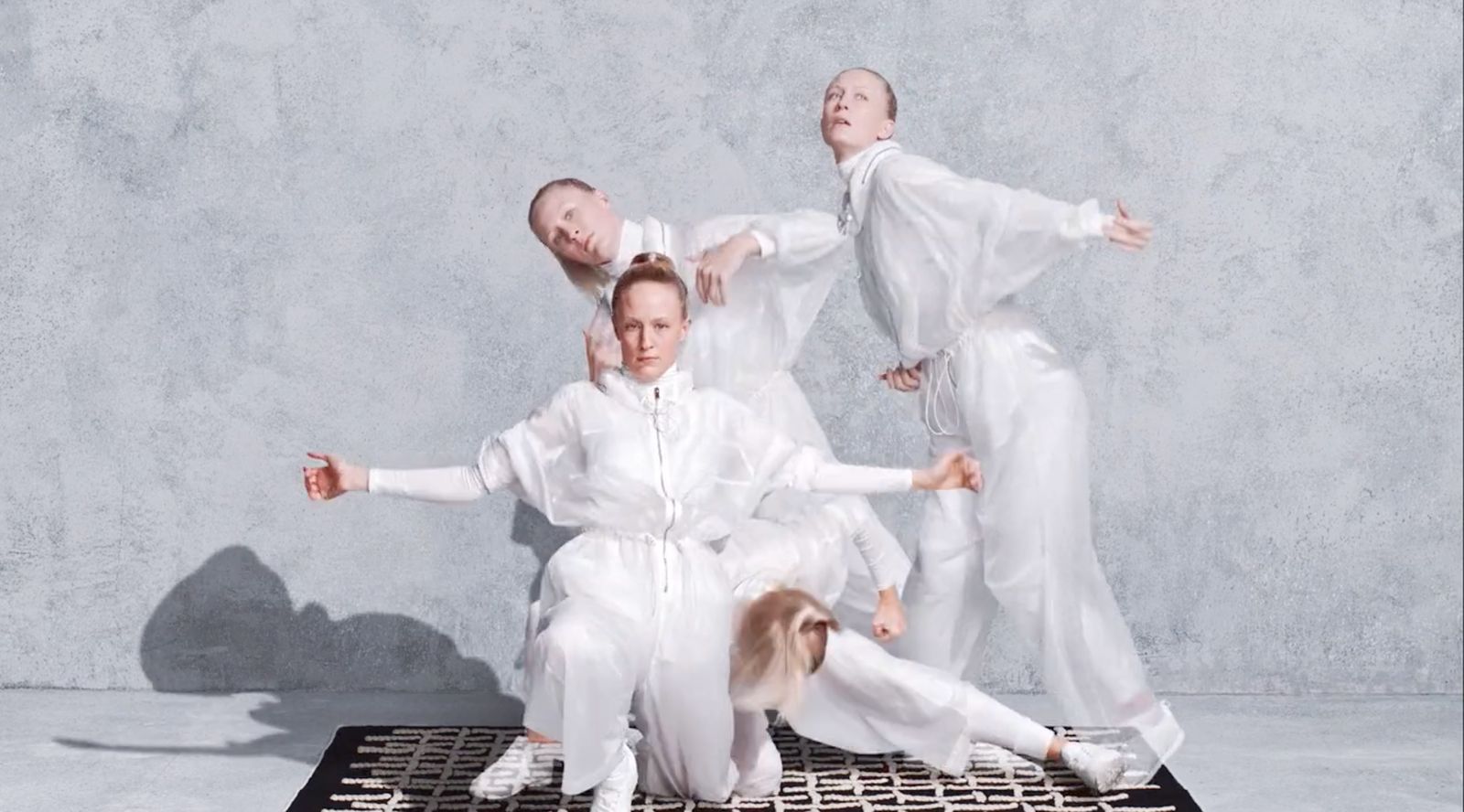 a group of people sitting on top of a rug