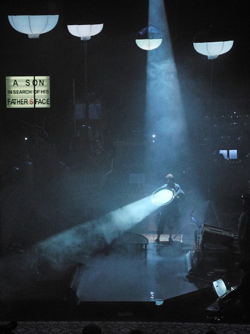 a person standing on a stage holding a light