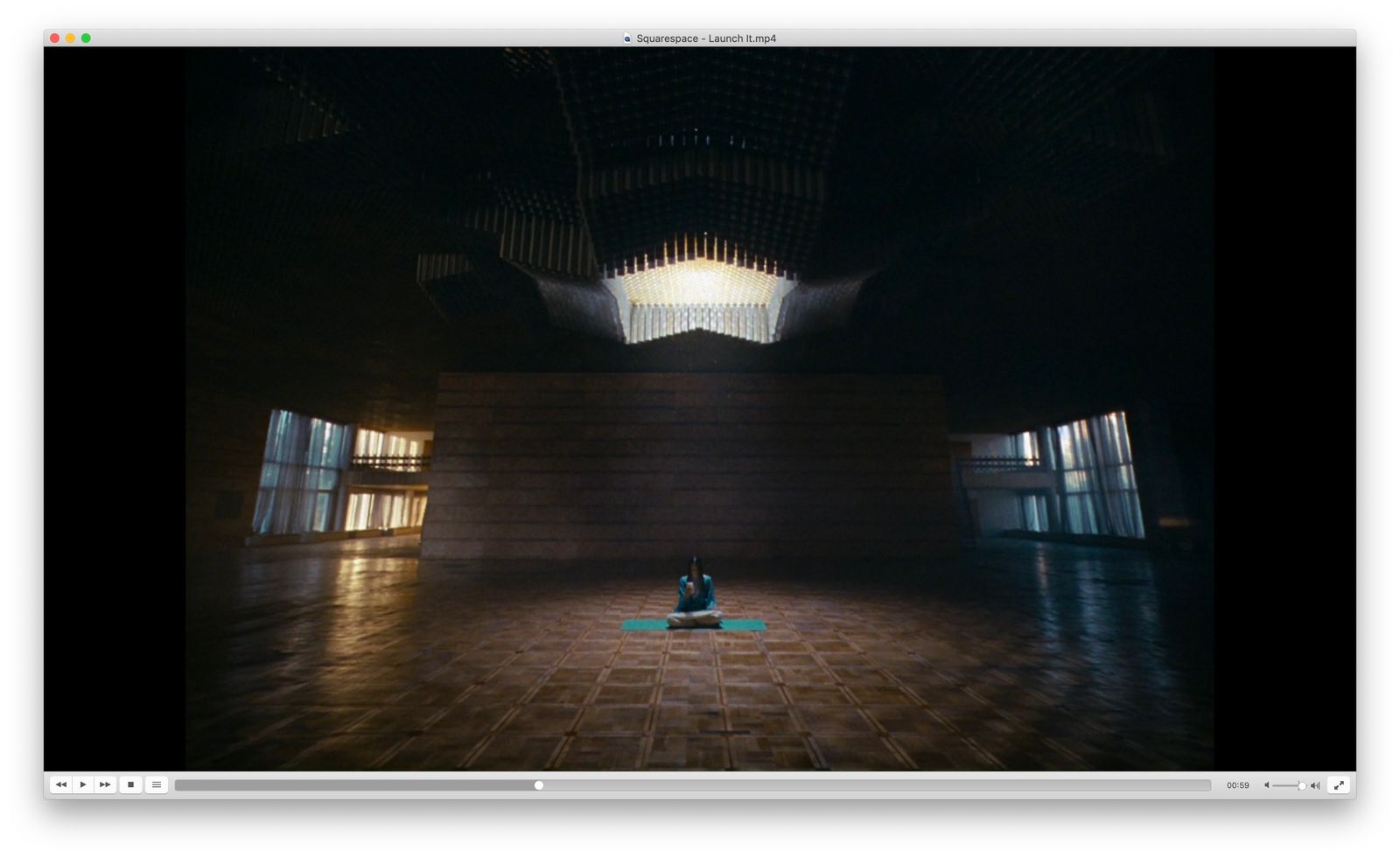 a person sitting on a floor in a dark room