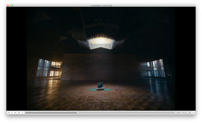 a person sitting on a floor in a dark room