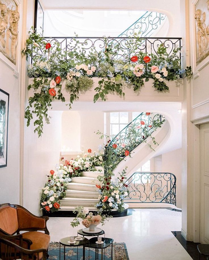 a staircase decorated with flowers and greenery