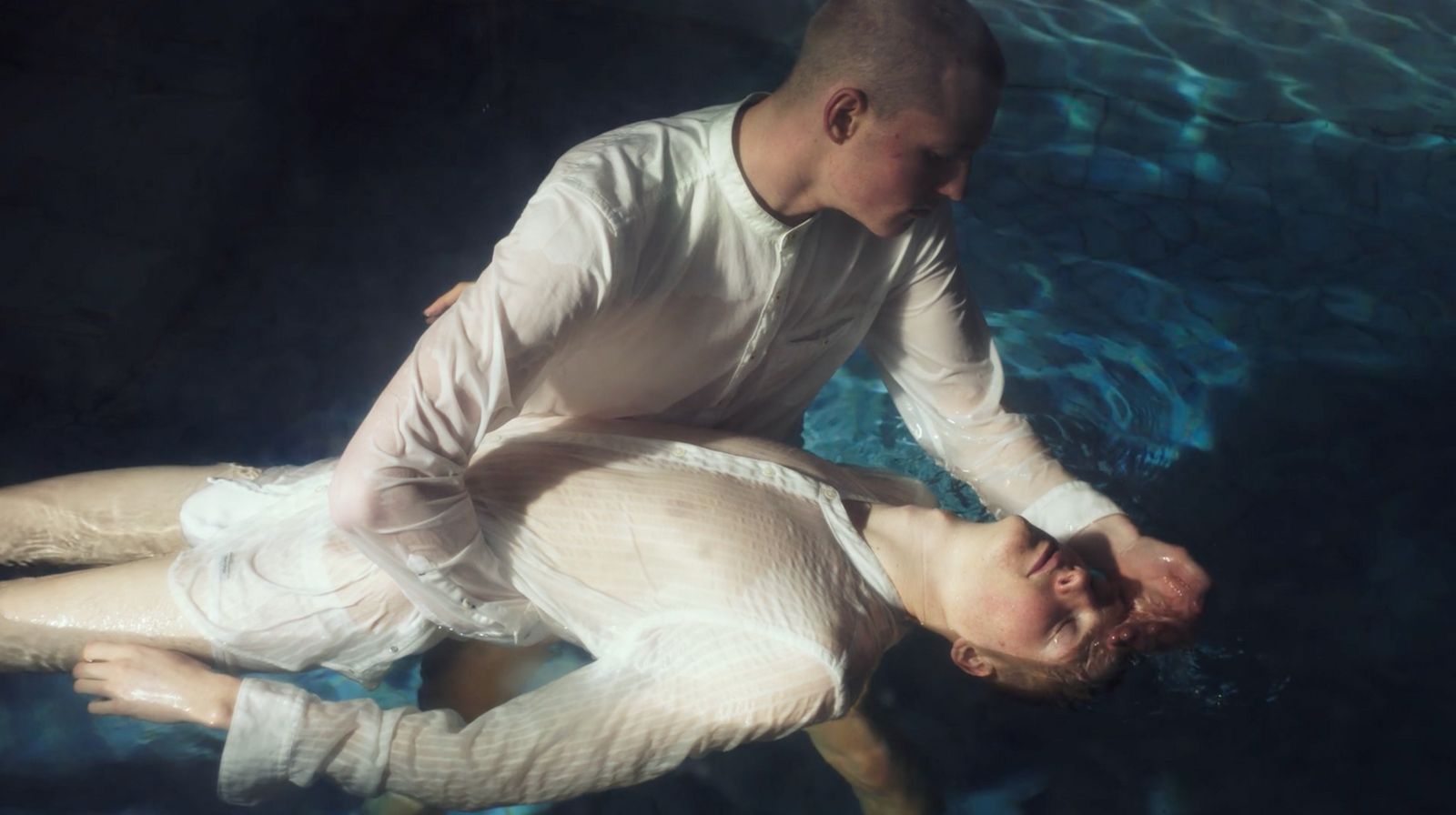 a man and a woman are floating in the water