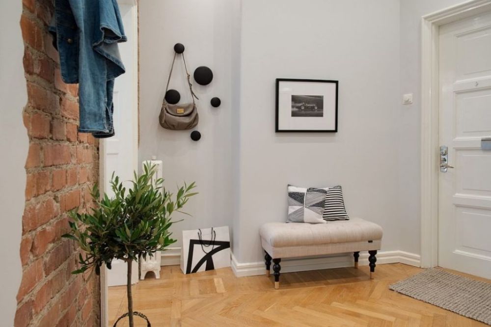 a living room with a couch and a potted plant