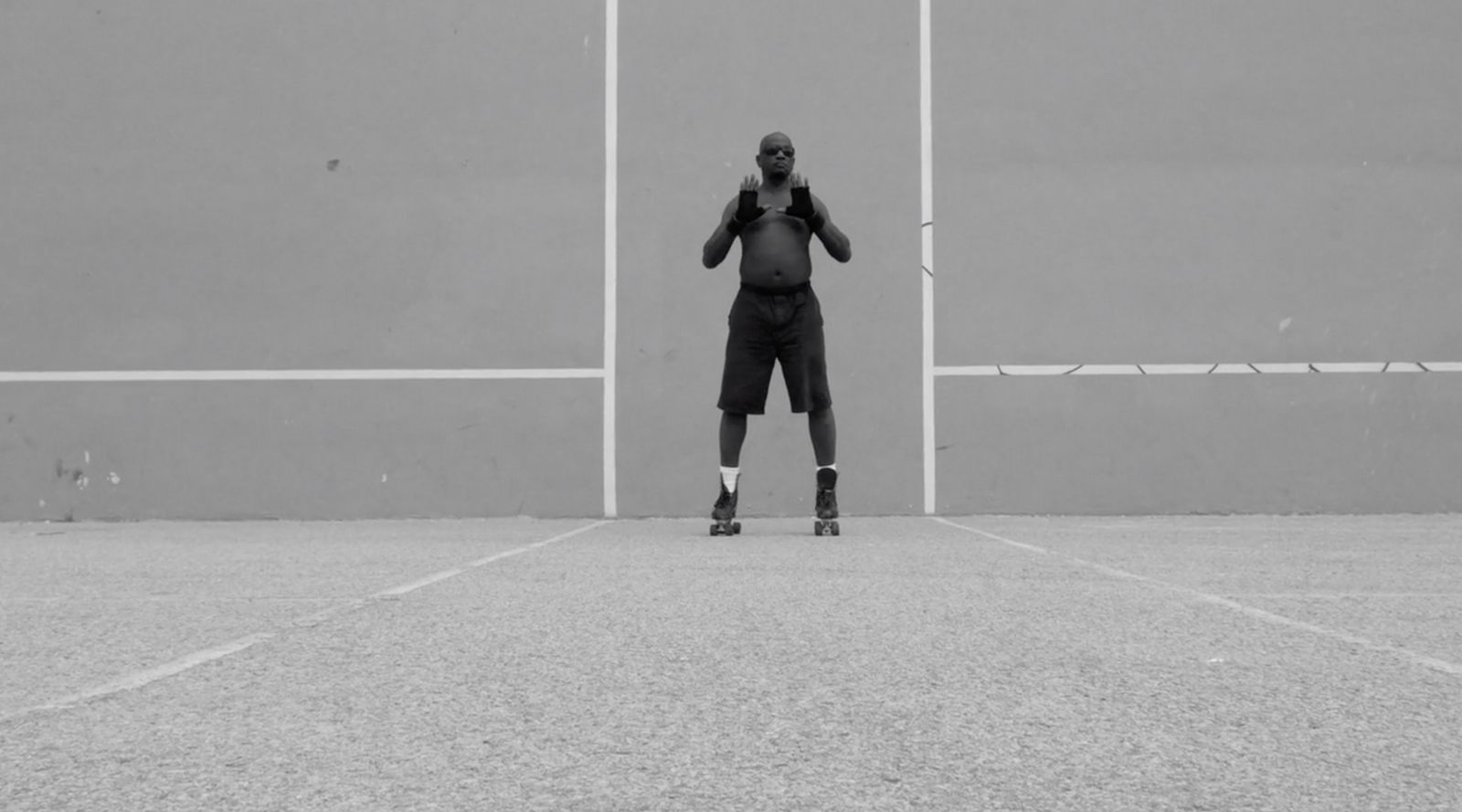 a man standing on top of a tennis court holding a racquet