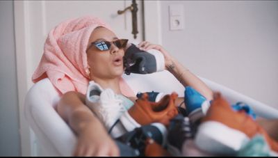 a woman in a bath tub with a towel on her head