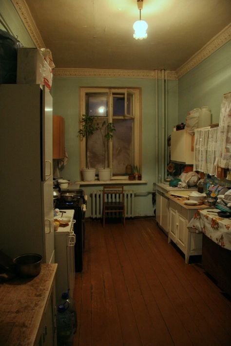 a kitchen filled with lots of clutter next to a window