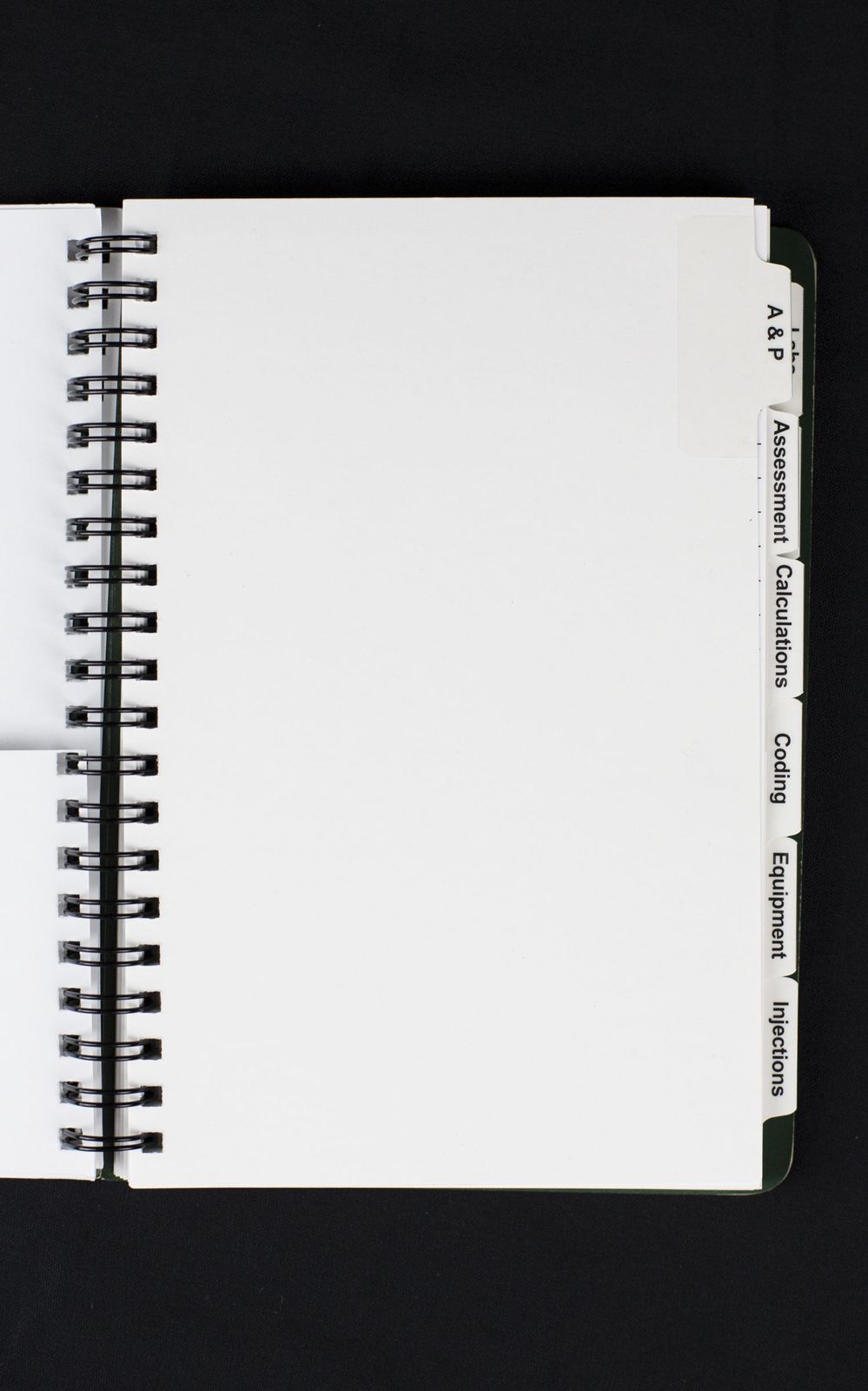 a white spiral notebook with a black cover