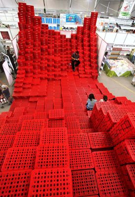 a group of people standing around a giant red object