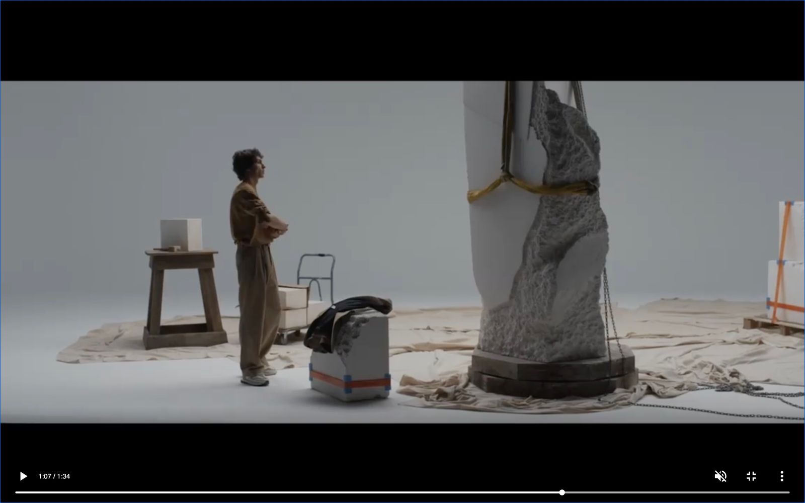 a man standing in front of a sculpture