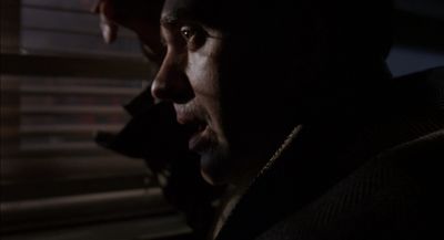 a man talking on a cell phone in a dark room