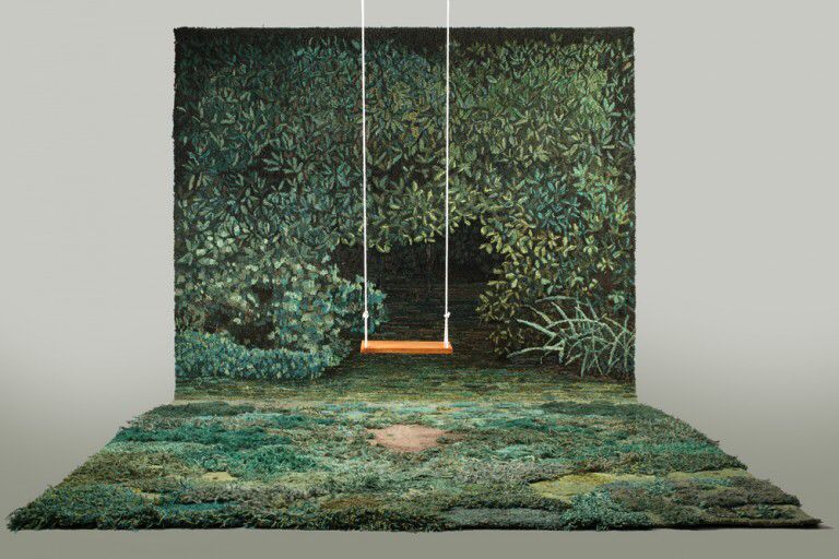 a room with a green carpet and a swing