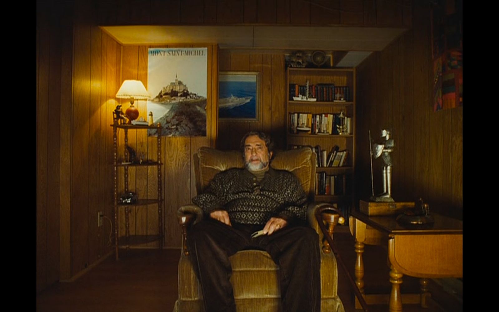 a man sitting in a chair in a living room