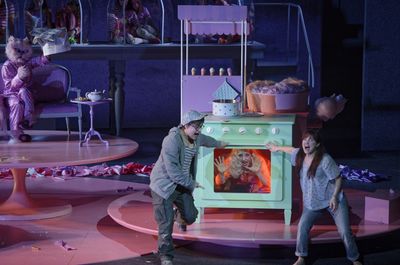 a man and a woman standing in front of an oven