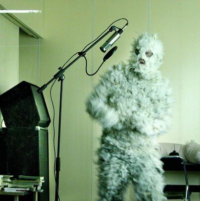 a man in a furry suit standing in front of a microphone