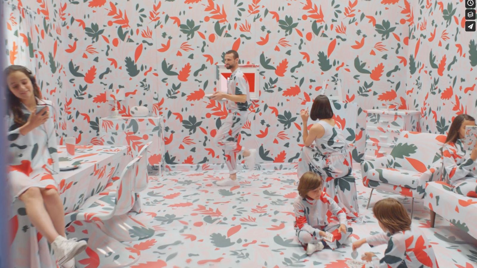 a group of people in a room with a wallpaper