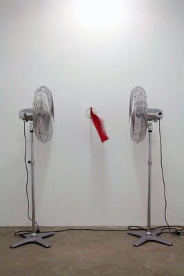 a couple of metal fans sitting on top of a floor