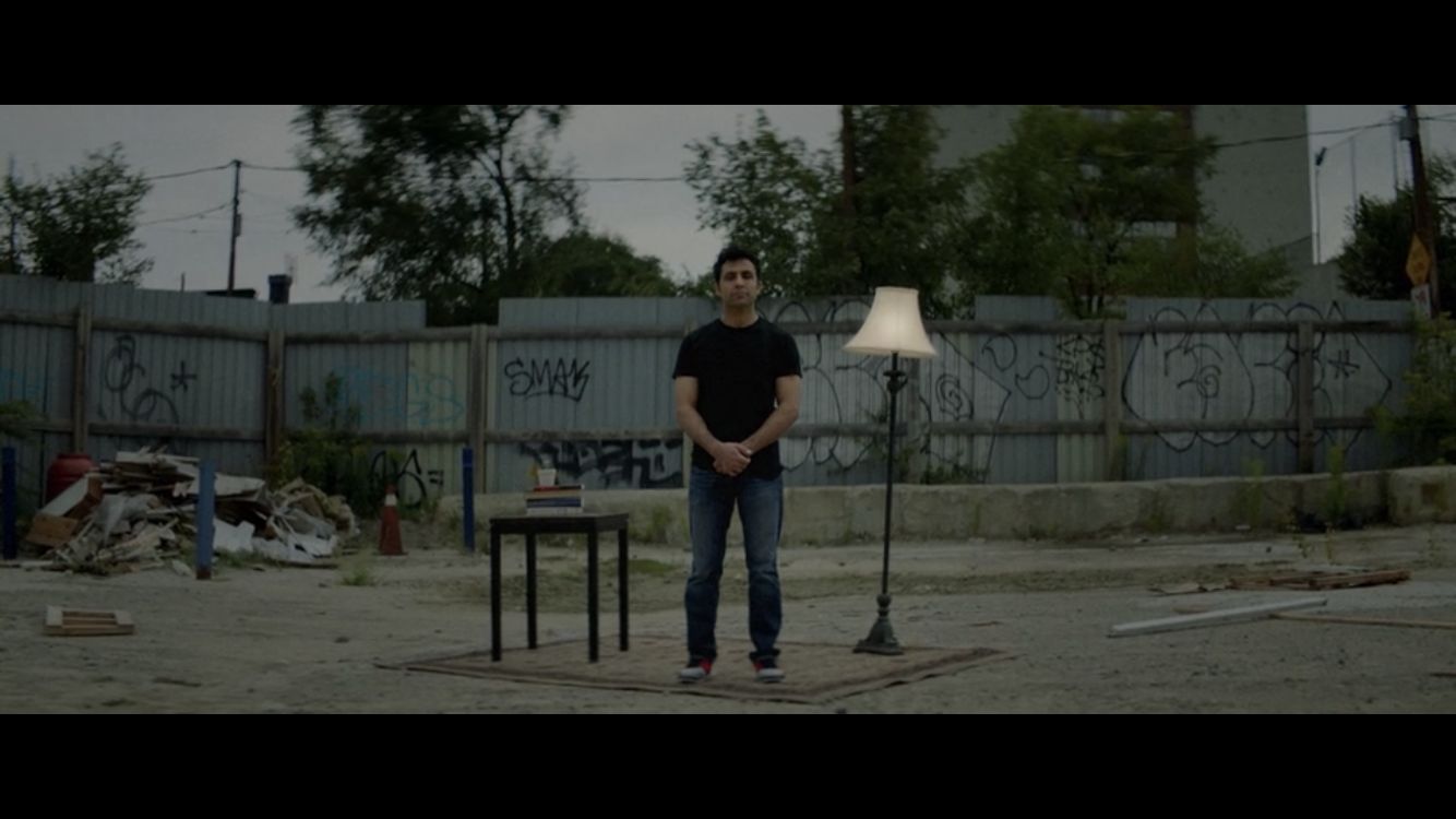 a man standing next to a lamp in a yard