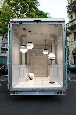 a white truck with a large open door on the back of it