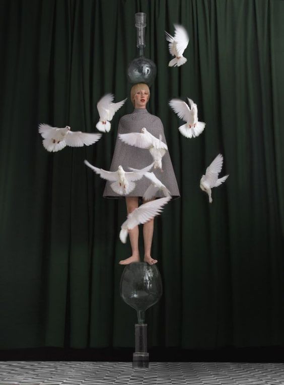 a statue of a woman surrounded by white birds