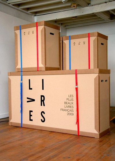 a large cardboard box sitting on top of a hard wood floor