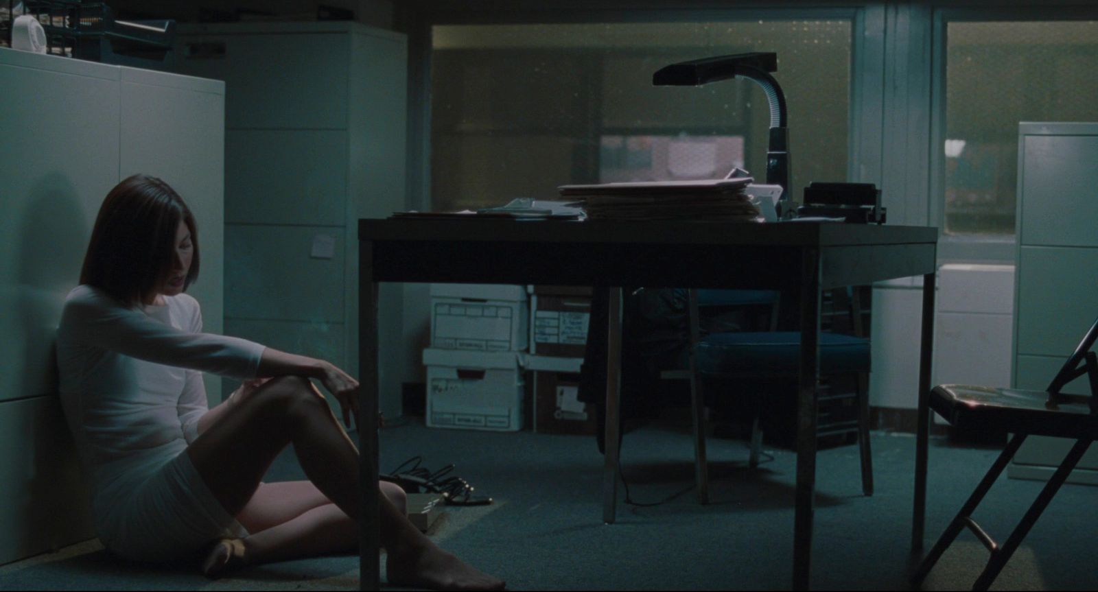 a woman sitting on the floor in a room