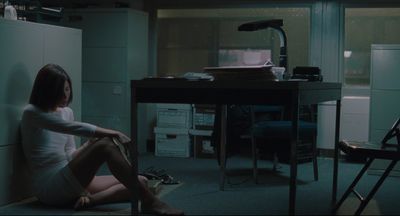 a woman sitting on the floor in a room