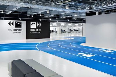 a large indoor track with a bench in front of it