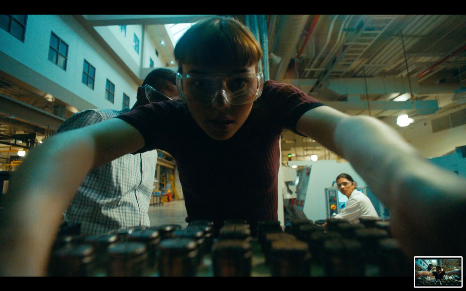 a man in glasses looking at stacks of coins