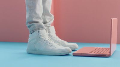 a person standing next to a laptop computer