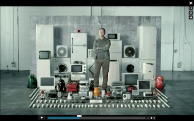 a man standing in front of a bunch of appliances